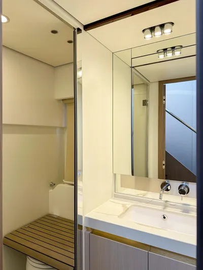  Yacht Photos Pics Luxurious bathroom interior of 2024 Azimut 60 Fly yacht, featuring modern fixtures and elegant design.