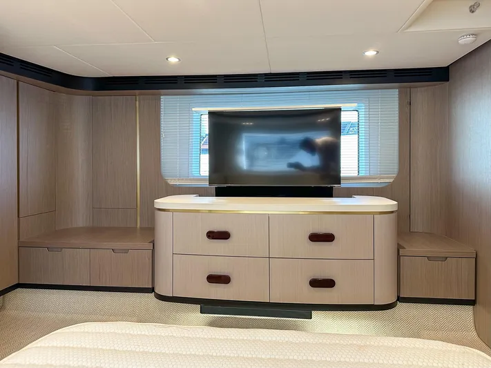  Yacht Photos Pics Luxurious interior of 2024 Azimut 60 Fly yacht with modern TV and cabinetry.