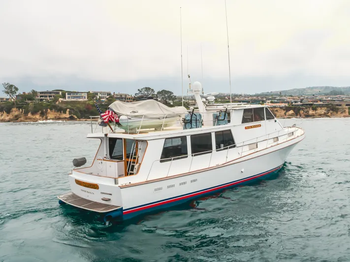 Vin Santo Yacht Photos Pics 1984 Vic Franck pilothouse yacht on ocean near coastal homes.
