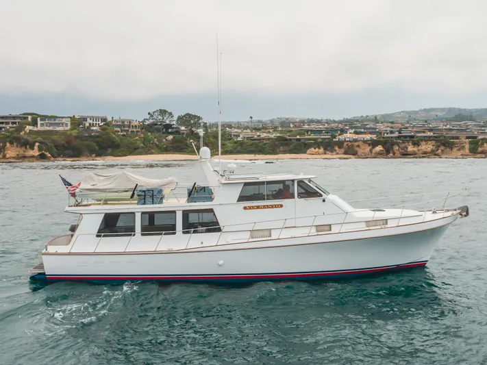 Vin Santo Yacht Photos Pics 1984 Vic Franck pilothouse yacht cruising near coastal homes.