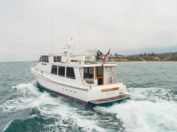 Vin Santo Yacht Photos Pics 1984 Vic Franck pilothouse yacht cruising on open water, rear view.