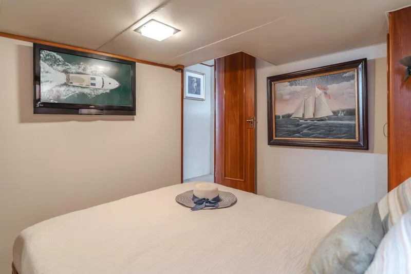 Vin Santo Yacht Photos Pics Cozy bedroom in 1984 Vic Franck pilothouse with nautical decor and wall art.