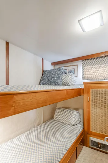 Vin Santo Yacht Photos Pics Cozy bunk beds in 1984 Vic Franck pilothouse with patterned bedding and wooden accents.