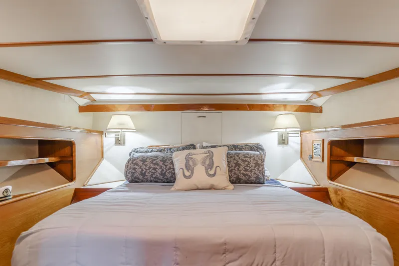 Vin Santo Yacht Photos Pics Luxurious 1984 Vic Franck pilothouse bedroom with elegant wood accents and cozy bedding.