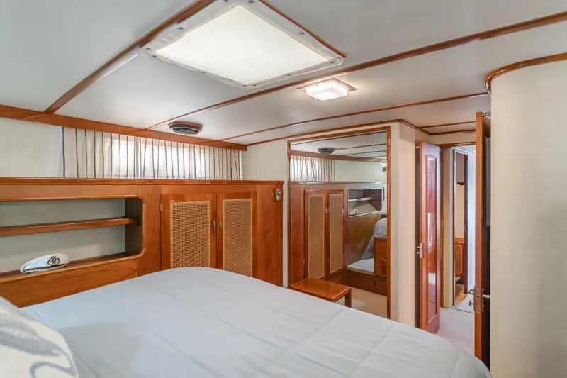 Vin Santo Yacht Photos Pics Luxurious 1984 Vic Franck pilothouse interior with wood paneling and cozy sleeping quarters.
