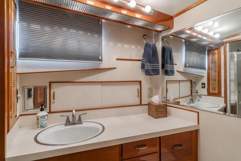 Vin Santo Yacht Photos Pics 1984 Vic Franck pilothouse bathroom with modern fixtures, wooden accents, and ample lighting.