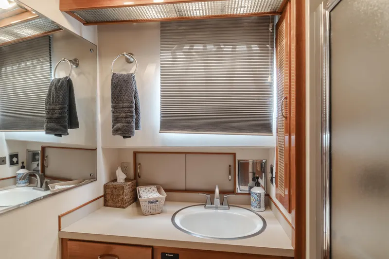 Vin Santo Yacht Photos Pics 1984 Vic Franck pilothouse bathroom with sink, mirror, and towels.