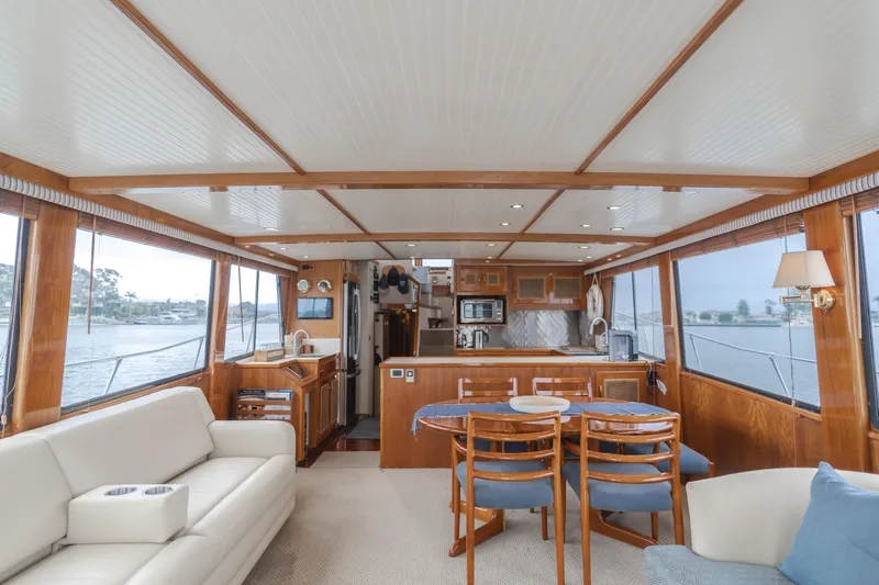 Vin Santo Yacht Photos Pics Luxurious 1984 Vic Franck pilothouse interior with elegant wood finishes and spacious seating area.