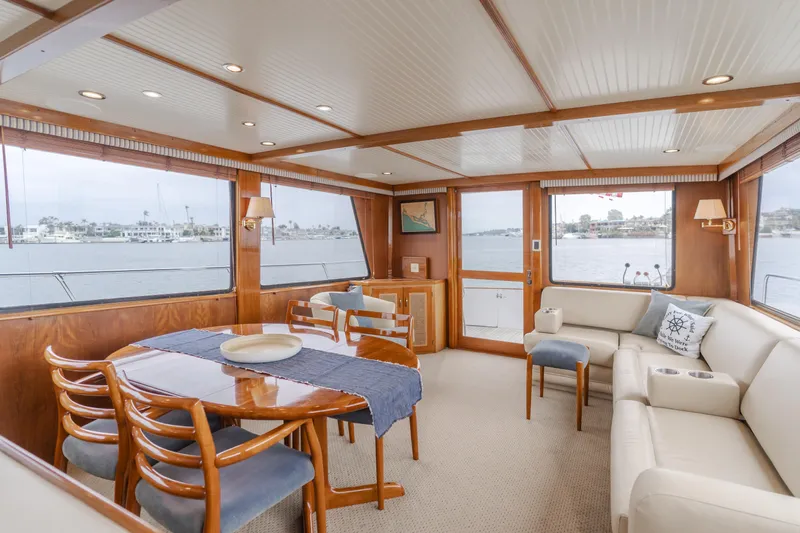 Vin Santo Yacht Photos Pics Luxurious 1984 Vic Franck pilothouse interior with elegant dining area and waterfront views.