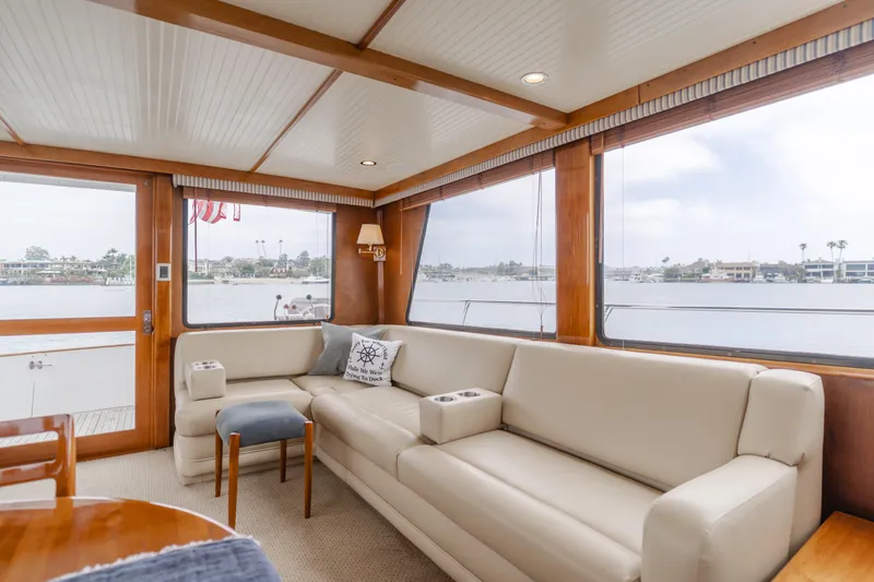 Vin Santo Yacht Photos Pics Luxurious 1984 Vic Franck pilothouse interior with beige seating and panoramic windows.