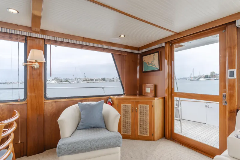 Vin Santo Yacht Photos Pics 1984 Vic Franck pilothouse interior with elegant wood paneling and waterfront view.