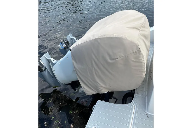  Yacht Photos Pics 2020 Boston Whaler 330 Outrage with covered outboard motor on water.