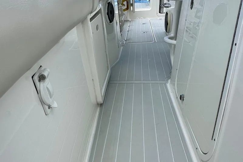  Yacht Photos Pics 2020 Boston Whaler 330 Outrage interior walkway with sleek, modern design.