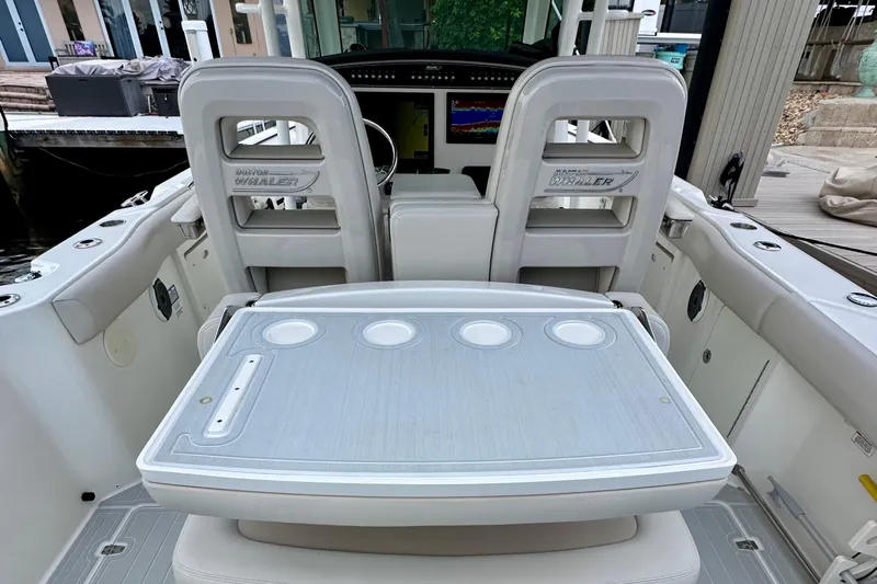  Yacht Photos Pics 2020 Boston Whaler 330 Outrage boat interior with seating and control panel.