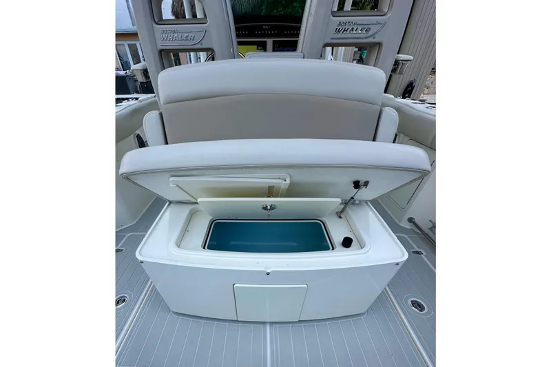  Yacht Photos Pics 2020 Boston Whaler 330 Outrage boat with open storage compartment and seating.