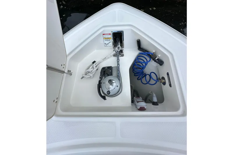  Yacht Photos Pics Anchor storage compartment on 2020 Boston Whaler 330 Outrage boat, featuring rope and coiled hose.