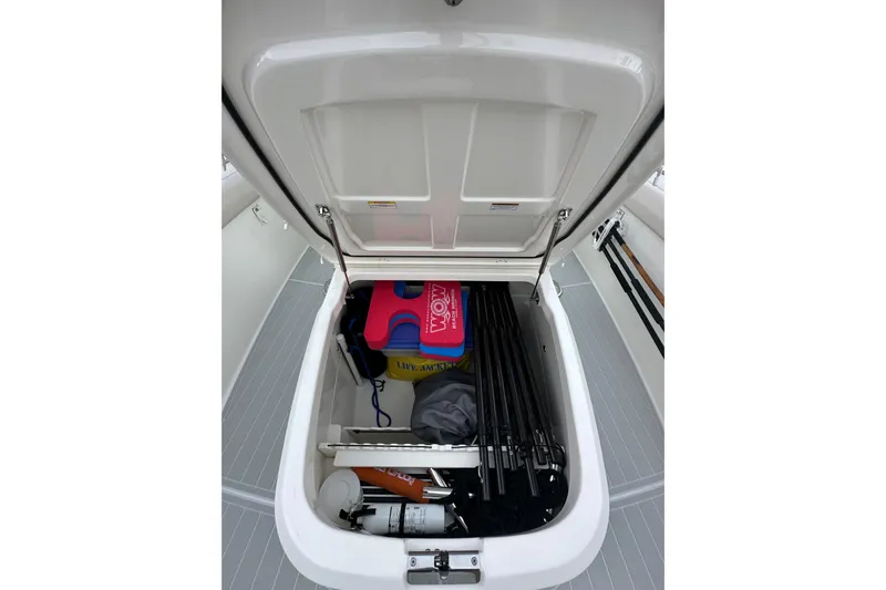  Yacht Photos Pics Open storage compartment on 2020 Boston Whaler 330 Outrage, containing life jackets and equipment.