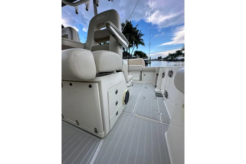  Yacht Photos Pics 2020 Boston Whaler 330 Outrage interior with seating and storage, overlooking a scenic waterfront.