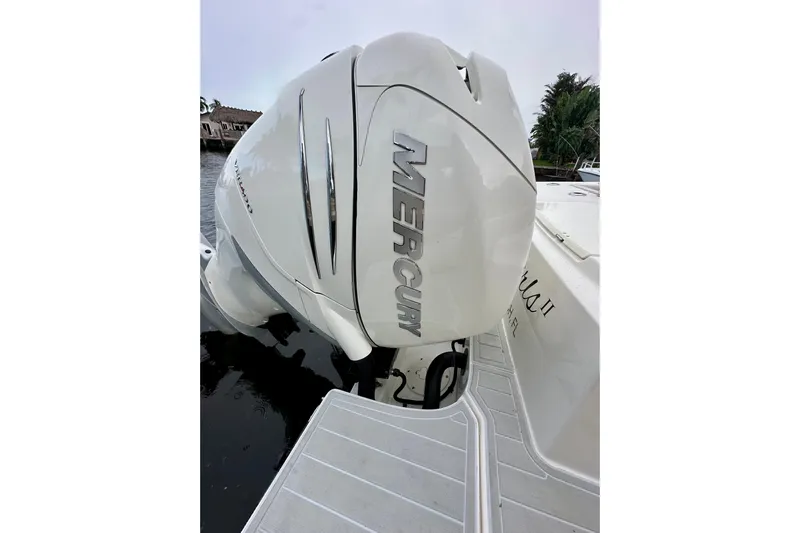  Yacht Photos Pics 2020 Boston Whaler 330 Outrage with Mercury outboard engine, docked by the water.