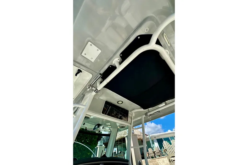  Yacht Photos Pics 2020 Boston Whaler 330 Outrage boat interior ceiling view with blue sky background.