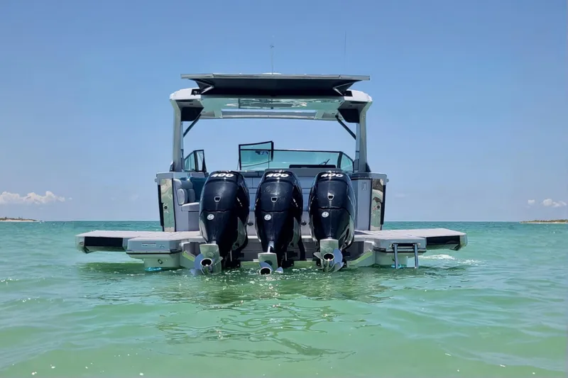 Happy Our II Yacht Photos Pics 2022 Aviara AV40 OB boat with triple outboard engines on clear water.