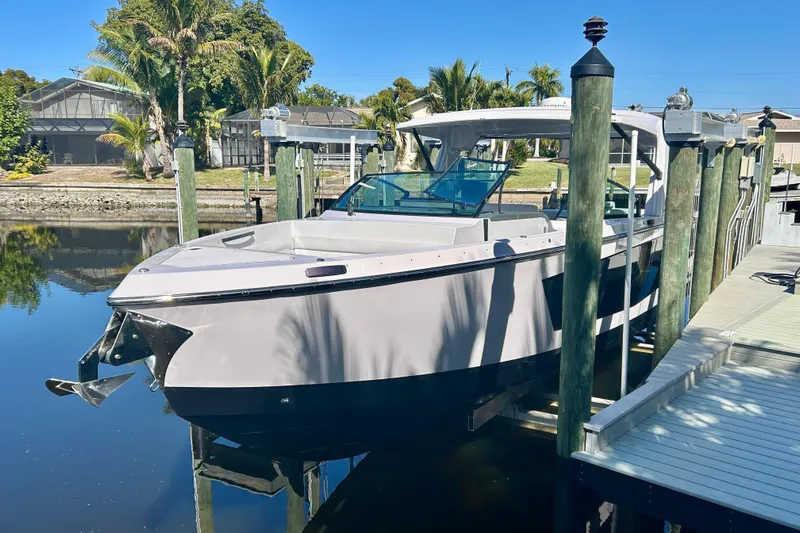 Happy Our II Yacht Photos Pics 2022 Aviara AV40 OB boat docked in a serene waterfront setting.