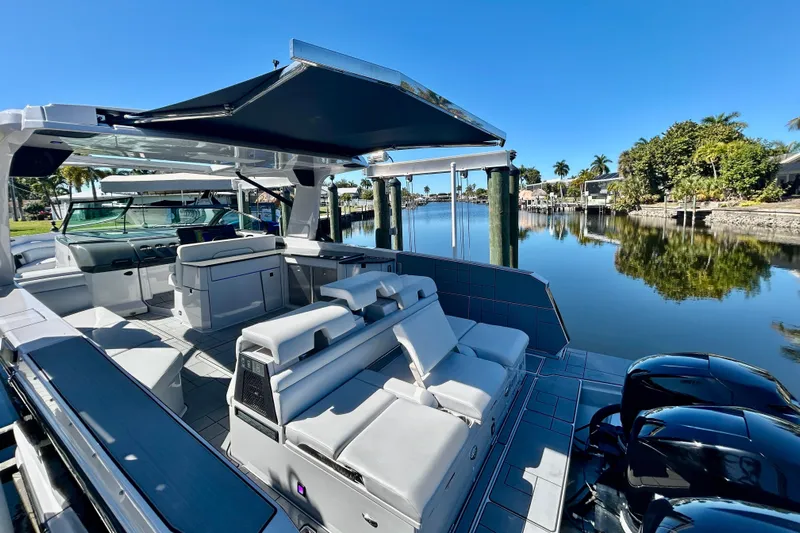 Happy Our II Yacht Photos Pics 2022 Aviara AV40 OB luxury boat with spacious seating on a serene waterfront.