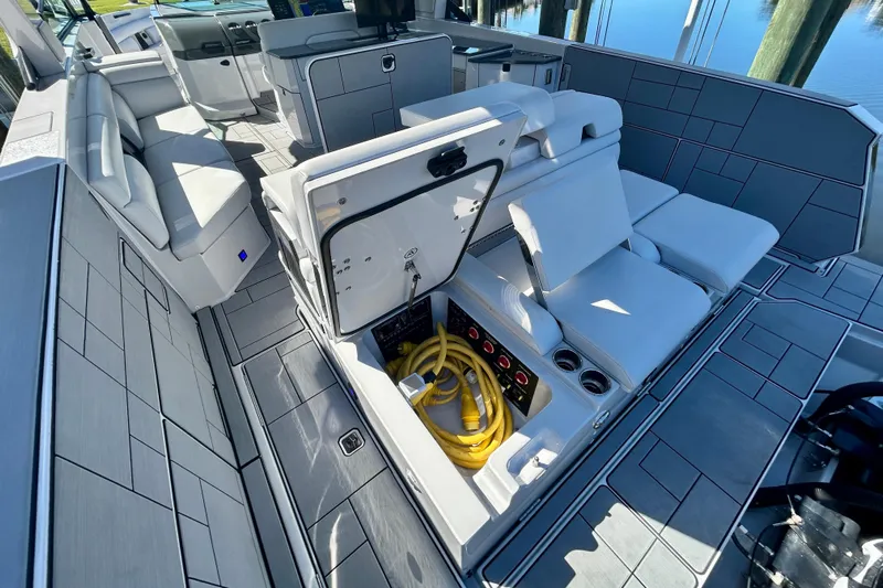 Happy Our II Yacht Photos Pics 2022 Aviara AV40 OB boat interior with storage compartment open, revealing yellow cables.
