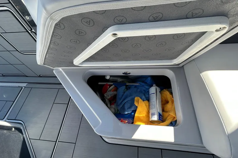 Happy Our II Yacht Photos Pics Storage compartment on 2022 Aviara AV40 OB boat with towels and cleaning supplies.