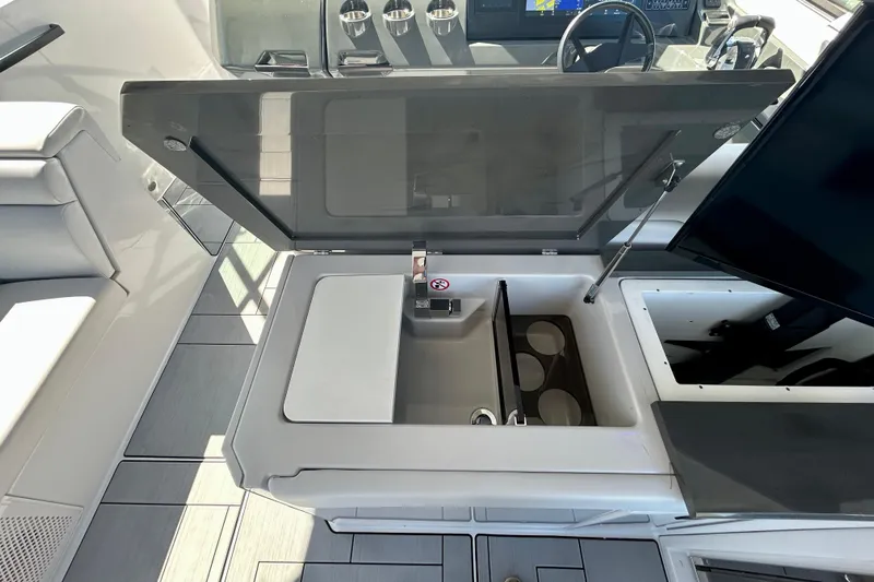 Happy Our II Yacht Photos Pics 2022 Aviara AV40 OB boat interior with open storage compartment and seating area.
