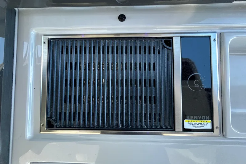 Happy Our II Yacht Photos Pics Built-in Kenyon grill on 2022 Aviara AV40 OB boat, featuring sleek design and control panel.