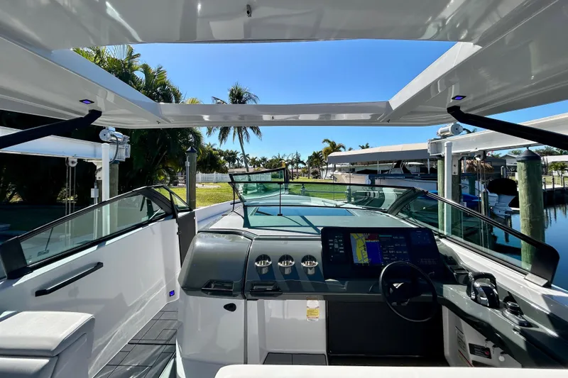 Happy Our II Yacht Photos Pics 2022 Aviara AV40 OB boat interior with modern dashboard and open canopy.