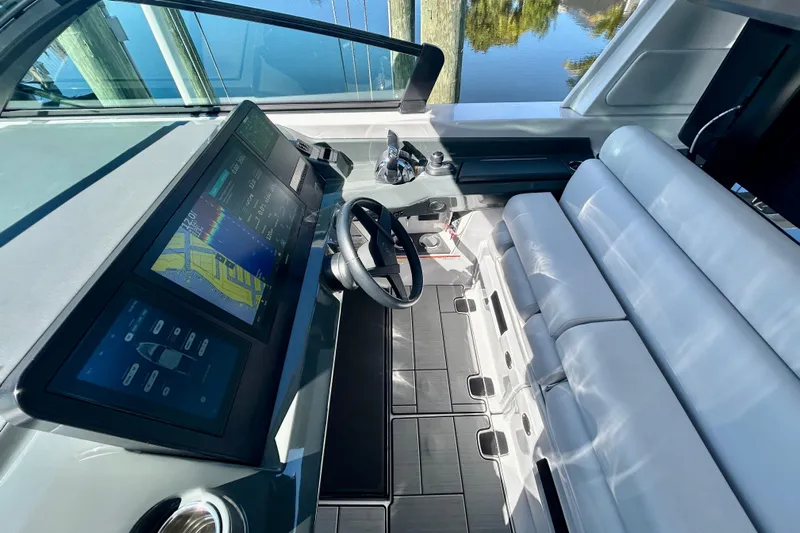 Happy Our II Yacht Photos Pics 2022 Aviara AV40 OB helm with modern controls and navigation screens.