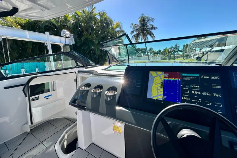 Happy Our II Yacht Photos Pics 2022 Aviara AV40 OB boat cockpit with advanced navigation screens and tropical background.