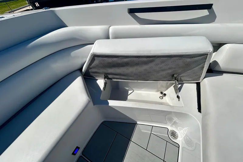 Happy Our II Yacht Photos Pics 2022 Aviara AV40 OB boat interior with open storage compartment and cushioned seating.