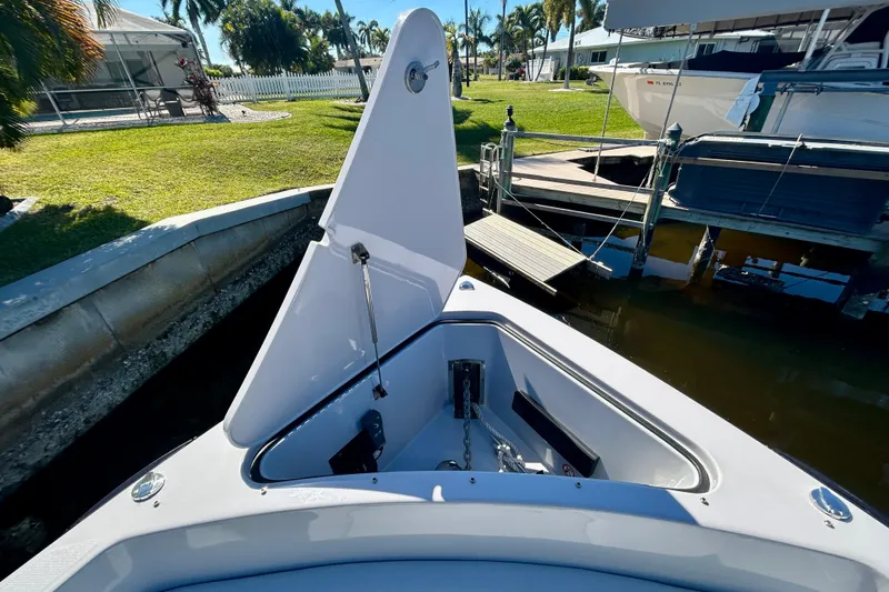Happy Our II Yacht Photos Pics 2022 Aviara AV40 OB boat anchor compartment at dockside, surrounded by lush greenery.