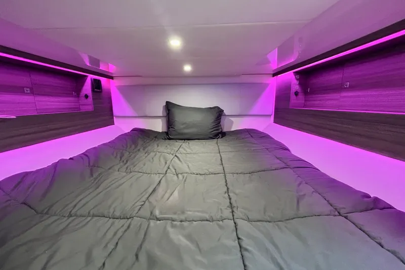 Happy Our II Yacht Photos Pics 2022 Aviara AV40 OB cabin with cozy bed and ambient purple lighting.
