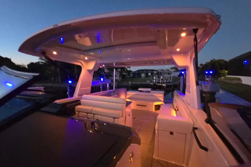 Happy Our II Yacht Photos Pics Luxurious 2022 Aviara AV40 OB boat interior with ambient lighting at dusk.