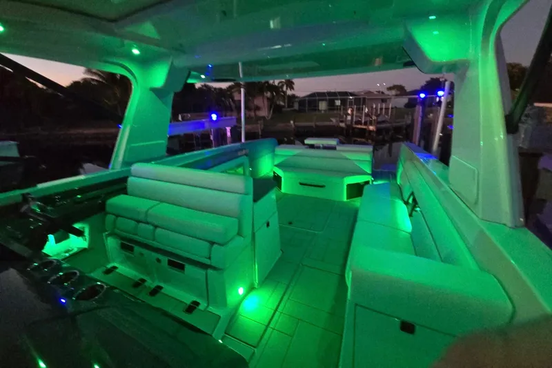 Happy Our II Yacht Photos Pics 2022 Aviara AV40 OB boat interior with green ambient lighting at dusk.