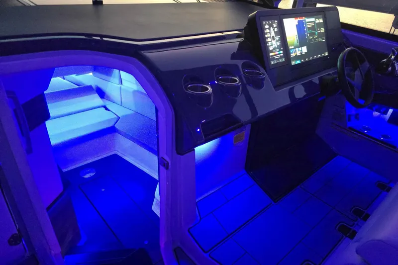 Happy Our II Yacht Photos Pics 2022 Aviara AV40 OB boat interior with blue LED lighting and modern dashboard.