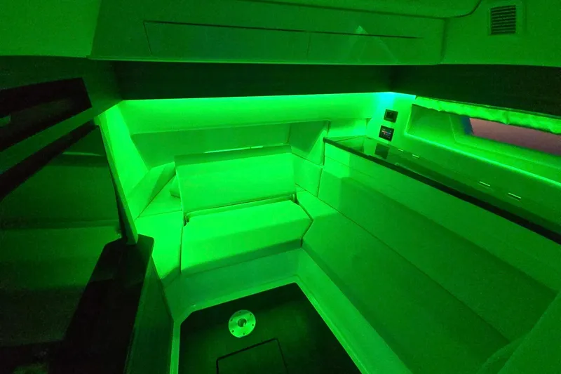Happy Our II Yacht Photos Pics 2022 Aviara AV40 OB cabin with green ambient lighting, modern seating, and sleek design.