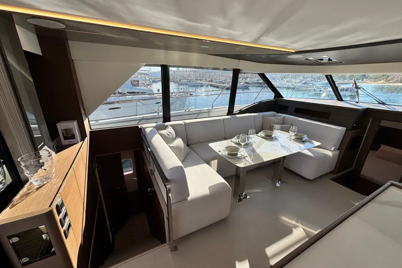  Yacht Photos Pics Luxurious interior of 2024 Prestige M48 yacht with elegant dining area and panoramic windows.