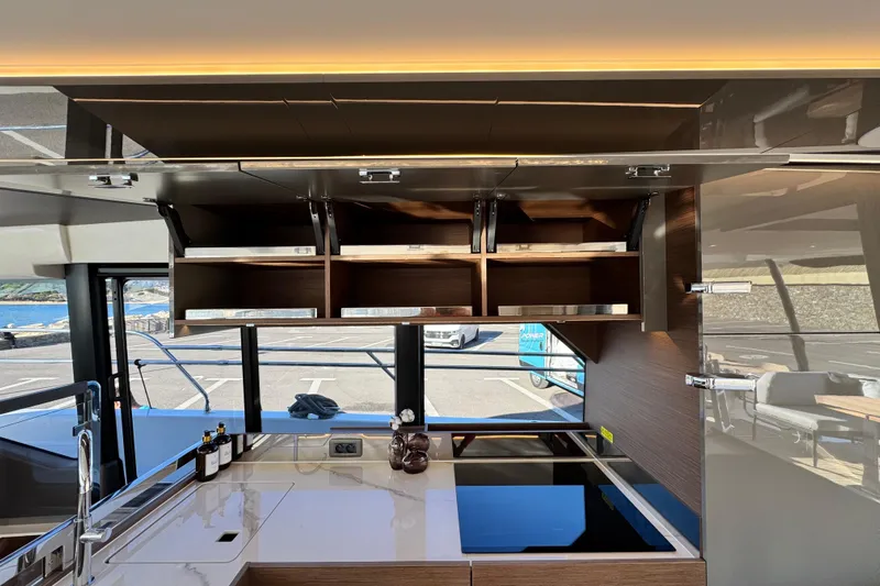  Yacht Photos Pics Modern kitchen interior of 2024 Prestige M48 yacht with sleek cabinetry and appliances.