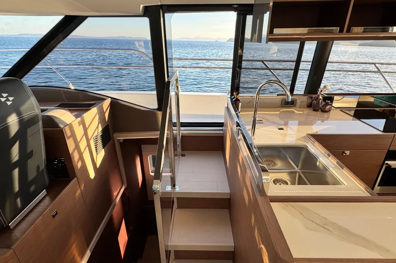  Yacht Photos Pics Luxurious interior of 2024 Prestige M48 yacht with modern kitchen and ocean view.