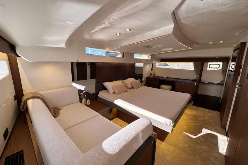  Yacht Photos Pics Luxurious 2024 Prestige M48 yacht interior with elegant bedroom and cozy seating area.
