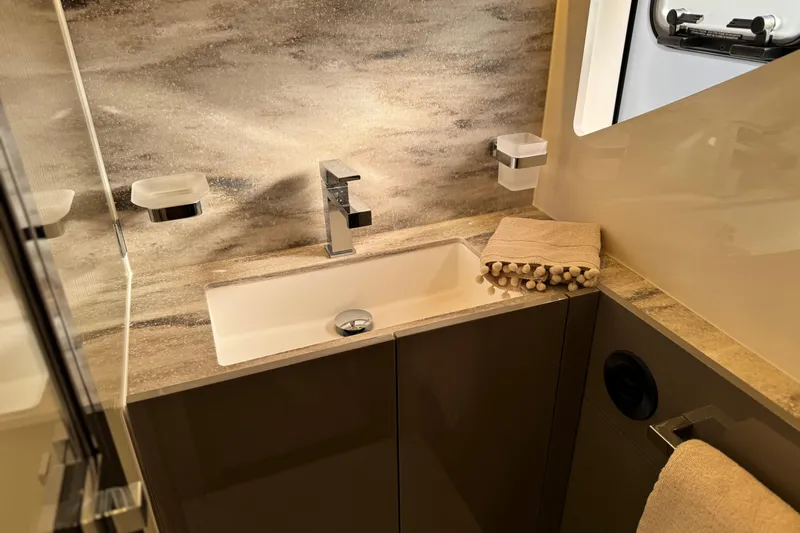  Yacht Photos Pics Luxurious bathroom in 2024 Prestige M48 yacht with modern sink and elegant decor.