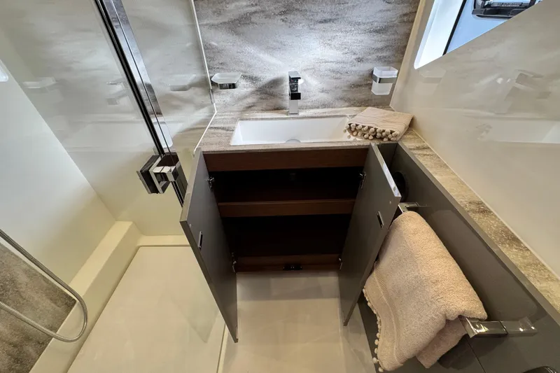  Yacht Photos Pics Modern bathroom in 2024 Prestige M48 yacht with open cabinet and sleek fixtures.