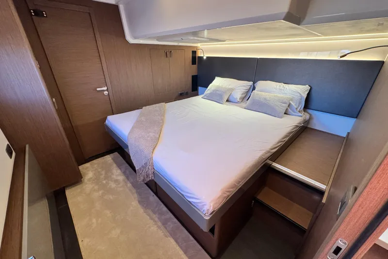  Yacht Photos Pics Luxurious bedroom interior of 2024 Prestige M48 yacht with modern design and cozy bedding.