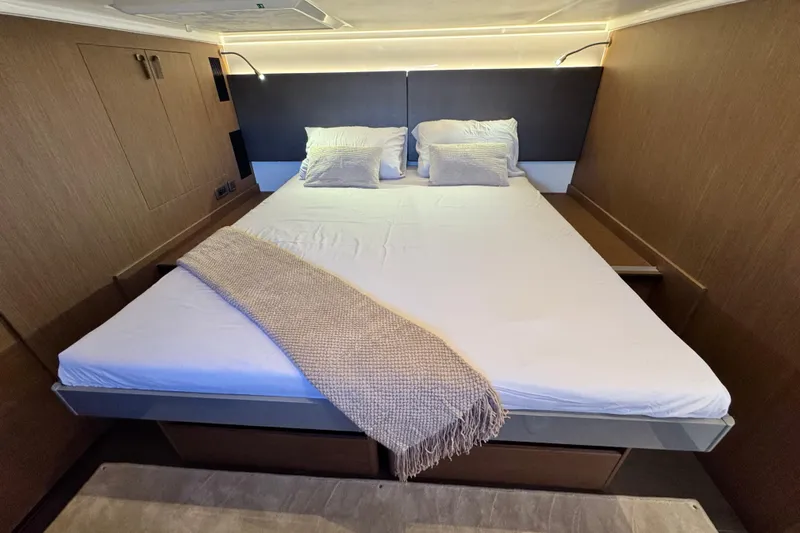  Yacht Photos Pics Luxurious bedroom interior of 2024 Prestige M48 yacht with elegant bedding and ambient lighting.