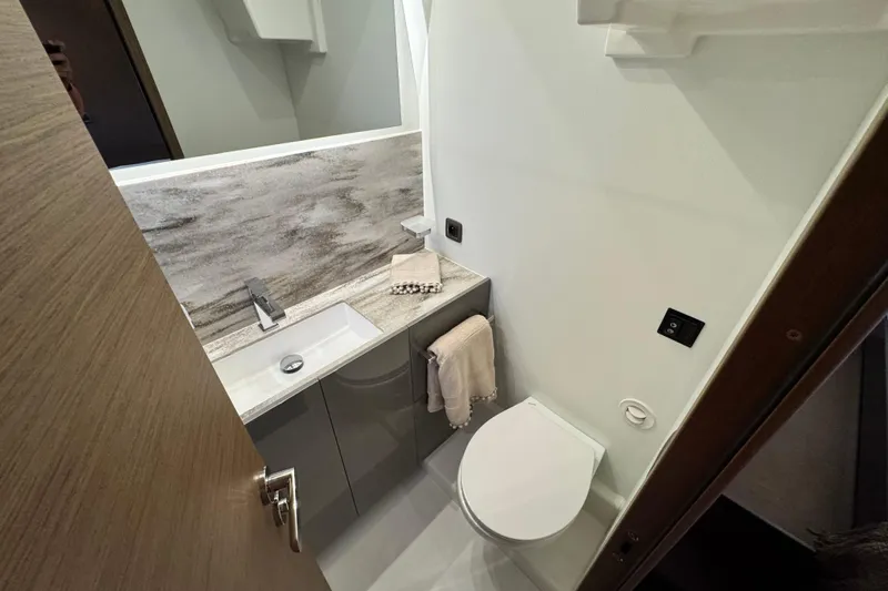  Yacht Photos Pics Modern bathroom in 2024 Prestige M48 yacht, featuring sleek sink and compact toilet design.